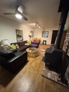 a living room with a couch and a fireplace at Home near the redwoods in Fort Bragg