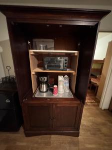 a cabinet with a coffee maker and a microwave at Home near the redwoods in Fort Bragg