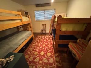 a room with two bunk beds and a rug at Home near the redwoods in Fort Bragg