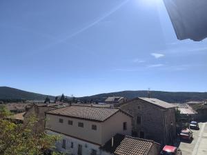 a view of a city with buildings and cars at La Royana in Vinuesa +5 photos