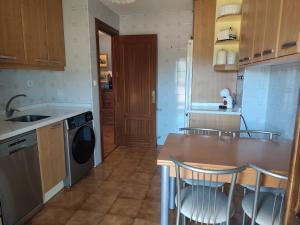 a kitchen with a table and chairs in it at La Royana in Vinuesa