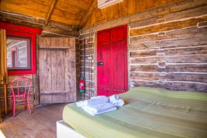 a bedroom with a red door and a bed in a room at Casa Del Sole in Camaiore
