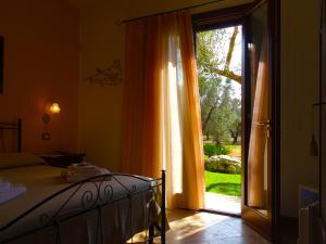 a bedroom with a bed and a sliding glass door at Biancolivo Gallipoli in Salento in Gallipoli +70 photos
