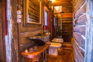 a bathroom with a sink and a toilet in a log cabin at Casa Del Sole in Camaiore +60 photos