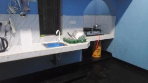 a small kitchen with a sink and a counter top at Zeenath Villa - Arugambay in Arugam Bay +18 photos