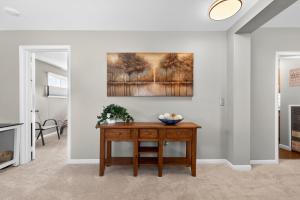 a living room with a table and a painting on the wall at 404 Doc Susie home in Fraser +25 photos