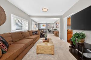 a living room with a brown couch and a table at 404 Doc Susie home in Fraser