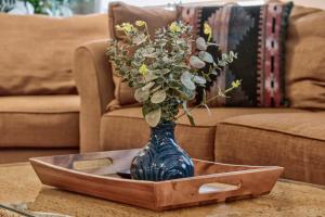 a blue vase with flowers in a box on a table at 404 Doc Susie home in Fraser