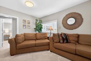 a living room with two brown couches and a mirror at 404 Doc Susie home in Fraser