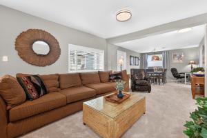 a living room with a brown couch and a table at 404 Doc Susie home in Fraser