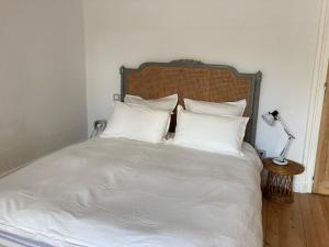 a white bed with white sheets and pillows at Maralocquet in Barbezieux-Saint-Hilaire +2 photos