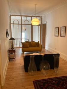 a living room with a couch and a table at Maralocquet in Barbezieux-Saint-Hilaire