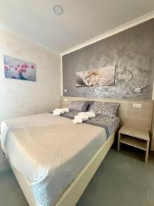 a bedroom with a large bed with white sheets at Maria House in Parghelia +6 photos