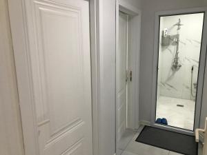 a bathroom with a white door and a mirror at Astara Villa Boutique Hotel in Astara +25 photos