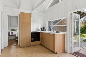 a kitchen with a sink and a counter top at Charming Cottage Near The Water in Holbæk