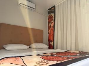 a bedroom with a bed with a painting on the wall at Cnr in Manavgat