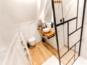 a bathroom with a sink and a mirror at MRODBNB - Appart Neuf - Vue Mer - 25m Plage & Resto - Ciné - cheminée - Popcorn in Cancale