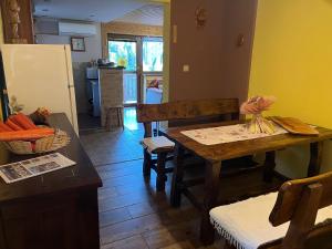 a kitchen with a wooden table and a dining room at Chata Dáša in Poráč +7 photos