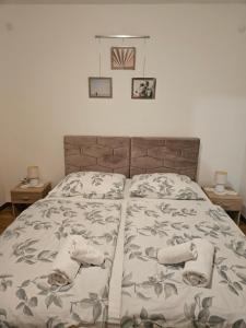 a bedroom with a bed with towels on it at Apartments Vidakovic in Ugljan