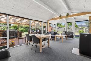 an open living room with a table and chairs at Close To The Beach With Outdoor Spa in Slagelse