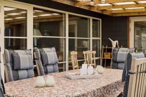 a table and chairs on a patio at Close To The Beach With Outdoor Spa in Slagelse