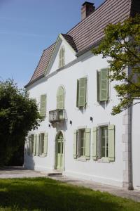 a white house with green shutters at Château Lagelouse in Mimbaste