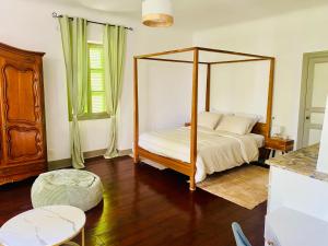 a bedroom with a canopy bed and a table at Château Lagelouse in Mimbaste