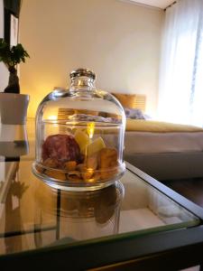 a glass jar filled with food on a glass table at La Dimora dell'Arte in Bari