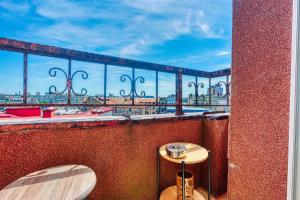 a balcony with a table and a view of the city at Old Town Smârdan Apartment - Central Lively Area in Bucharest +7 photos