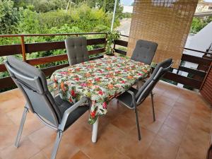 a table and four chairs on a balcony at Apartments Vidakovic in Ugljan +88 photos