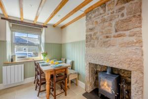 a dining room with a table and a fireplace at 3 Bed in Morpeth oc-75083 in Harbottle