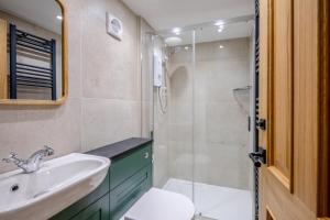 a bathroom with a sink and a toilet and a shower at 3 Bed in Morpeth oc-75083 in Harbottle +23 photos