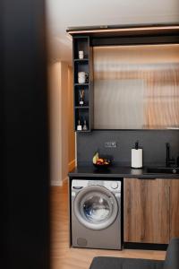 a washing machine in a kitchen with a counter at Maison Sidra in Thessaloniki +35 photos