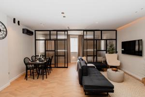 a living room with a couch and a dining room at Maison Sidra in Thessaloniki