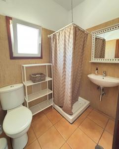 a bathroom with a toilet and a sink at Casa Victoria in Antigua
