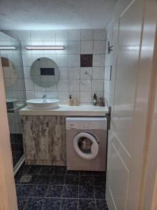 a bathroom with a washing machine and a sink at Lithos Home Agia Galini in Agia Galini +33 photos