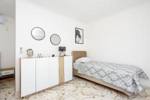 a white bedroom with a bed and mirrors on the wall at Villa Kaplan Verde in Stolac +54 photos