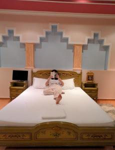 a woman taking a picture of a bed with a camera at Villa Celaj “The Castle” in Krujë +49 photos