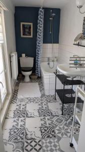 a bathroom with a tub and a toilet and a sink at Manoir du Taillis in Heugon +111 photos