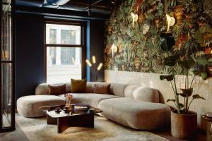 a living room with a couch and a table at Leonardo Boutique Hotel The Lancaster Amsterdam in Amsterdam