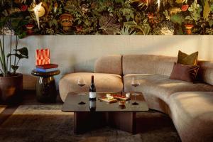 a living room with a couch and a table with wine glasses at Leonardo Boutique Hotel The Lancaster Amsterdam in Amsterdam