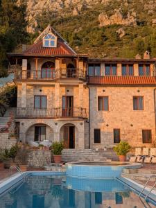 a large house with a swimming pool in front of it at Villa Celaj “The Castle” in Krujë