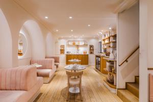 a living room with a couch and a table at Hôtel Oratio in Paris