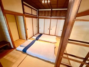 an empty room with two beds in it at SADO Stay 02 金山京町一軒家貸し切り in Sado