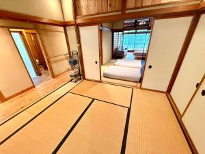 a room with a bedroom with a bed in it at SADO Stay 02 金山京町一軒家貸し切り in Sado +15 photos