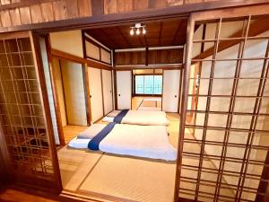 a small room with two beds in it at SADO Stay 02 金山京町一軒家貸し切り in Sado