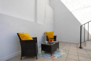 a living room with two chairs and a table at Sunstay Arroyo House Velez in Vélez-Málaga +10 photos