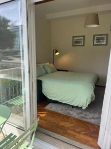 a bedroom with a bed and a sliding glass door at City Centre Cozy Apartment in Porto
