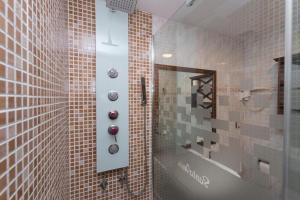 a tiled bathroom with a shower and a mirror at Hotel Santa Inés in Vinuesa +38 photos