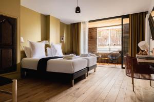 a bedroom with a large bed and a window at Le Moulin de Nouara in Ambert